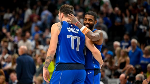 Dallas Mavericks’ Luka Doncic and Kyrie Irving embrace during Sunday’s matchup against the Charlotte Hornets.